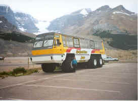 Diane standing next to a SnoCoach.