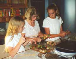 Diane, Megan, and Amy cooking supper.